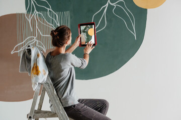 Anonymous designer shooting abstract ornament on wall