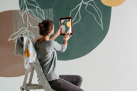 Anonymous designer shooting abstract ornament on wall