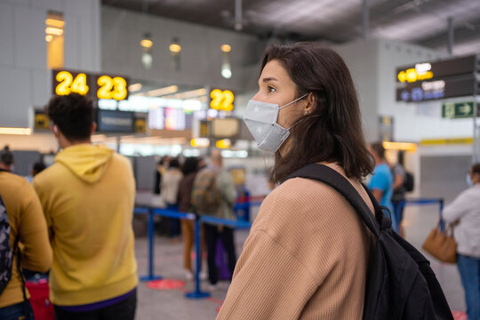 Woman With Mask Standing In The Airport Queue.