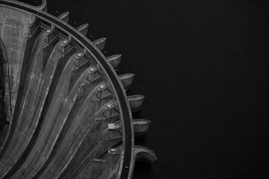 Aerial top view of a dam and reservoir water