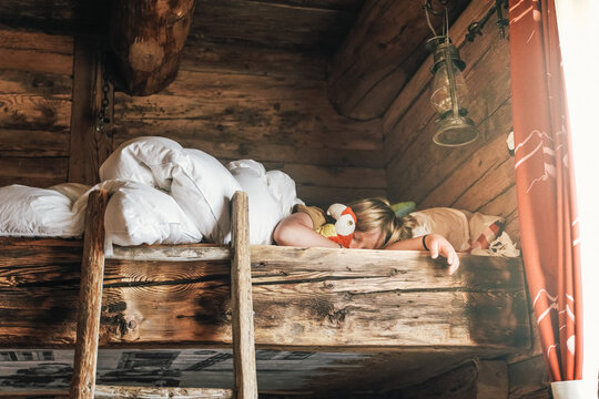 little boy and plush toy in bed