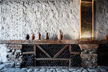 Ceramic jugs on wine shelf