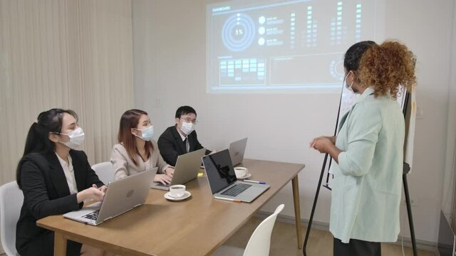 new normal new lifestyle , work colleage wering facemask in daily business meeting to prevent Covid-19