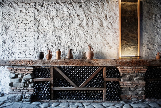 Ceramic jugs on wine shelf