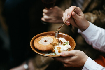 eating apple pie on a brown plate with a golden spoon