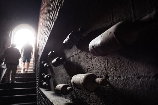 Anonymous people leaving dark cellar