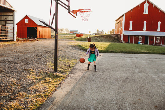 A Girl Dribbling A Basketball