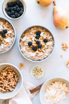 Homemade porridge topped with wild blackberries, walnuts and shr