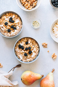 Homemade porridge topped with wild blackberries, walnuts and shr
