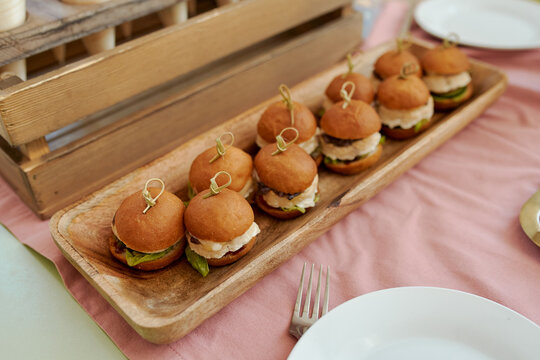 fresh mini burgers of various types on the buffet table for lunch