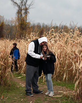 Family in Corn Maze Looking at Map