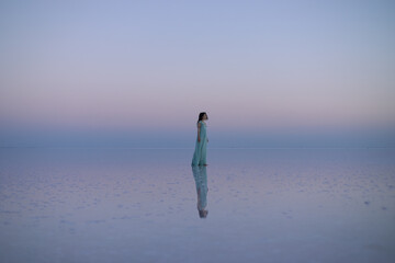 girl dress standing in pink water the sky is also pink