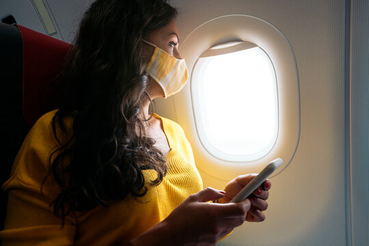 Woman Wearing Face Mask in Plane