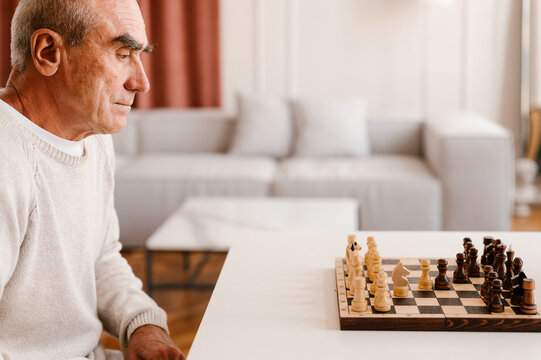 Senior Man Playing Chess Game Alone