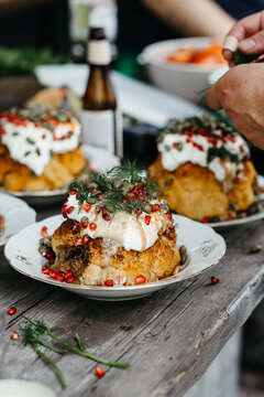 Baked cauliflower topped with cream, nuts and herbs.
