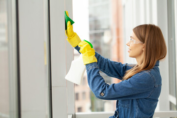 Cleaning concept, young woman with supplies cleaning office