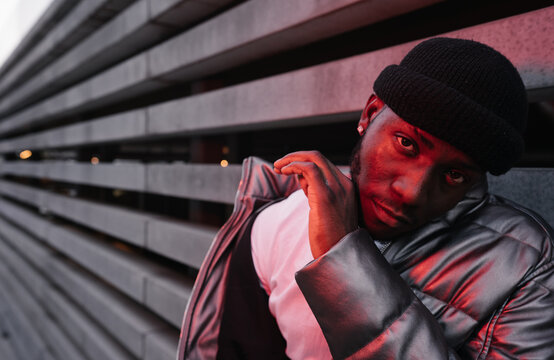 Stylish Man Illuminated By Red Light