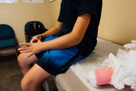 Boy with broken arm having cast cut off.