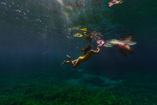 Two Children Playing In The Water
