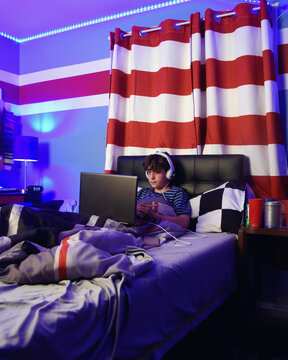 Teen Boy in Bedroom on Computer Laptop