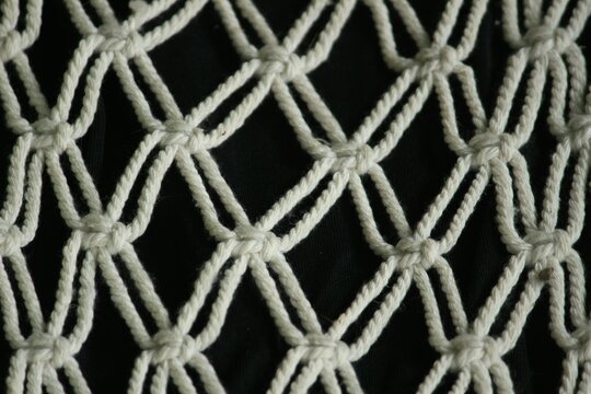 This art macrame craft made of crocheted rope for interior home decoration.
