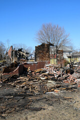 Burned out building, the remnants of a restaurant that was in a century house leaving heaps of rubble