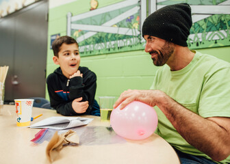 Dad and son at school science fair.