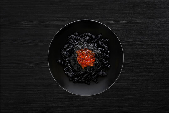 Black pasta with salmon caviar