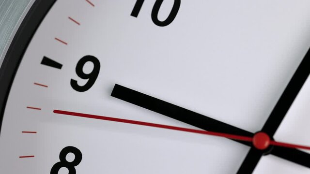 Large white wall clock Set the time for 9.00 o'clock. The red minute hand keeps running. Time lapse movie.