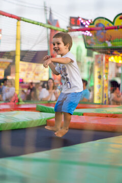 Kid jumping on a trampoline at the carnival