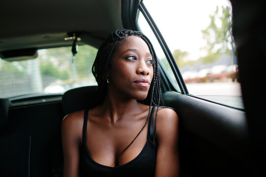 Young attractive woman in a car looking through the window