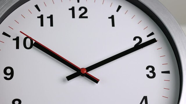 Large white wall clock Set the time for 10.10 o'clock. The red minute hand keeps running. Time lapse movie.
