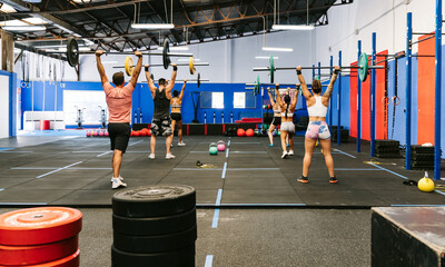 Sportsman and sportswomen with barbells