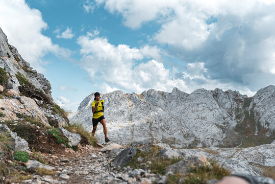 Fit active middle aged man running a rocky mountain trail