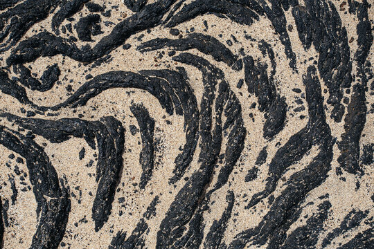 Lava flow partially covered by sand