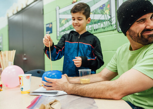 Dad and son at school science fair.