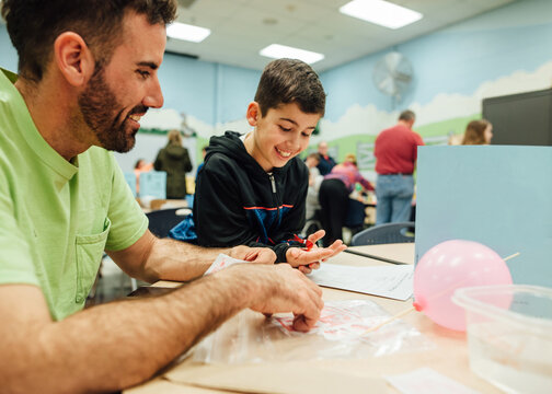 Dad and son at school science fair.