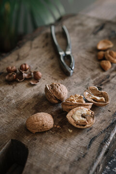 Still Life Of Opened Nuts On Wooden Cutting Board