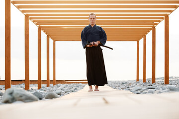 Focused warrior taking katana from scabbard