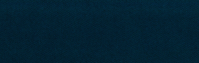 Dark blue paper background. Narrow horizontal photo in deep cobalt color. Textured surface template...