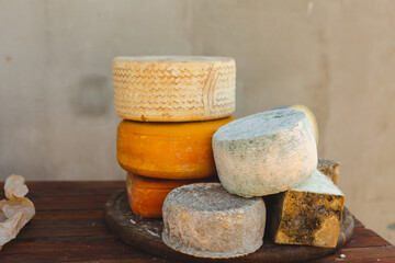 various types of cheese on a rustic wooden table