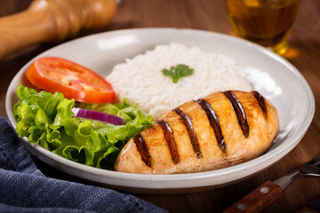 Grilled chicken with salad and rice.