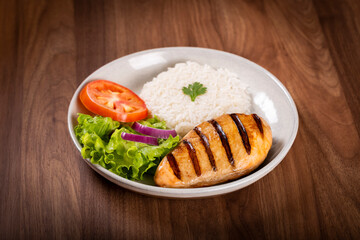 Grilled chicken with salad and rice.