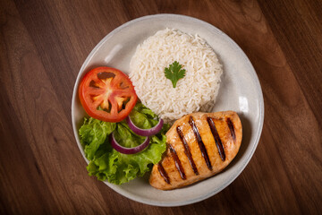 Grilled chicken with salad and rice.