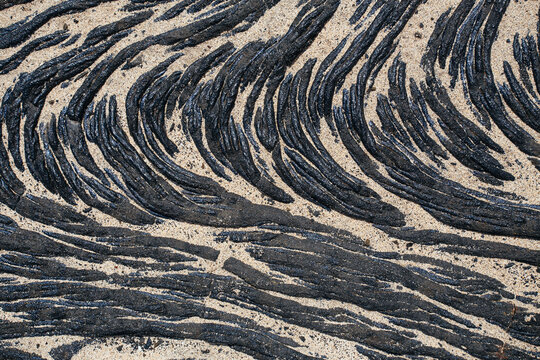 Lava flow partially covered by sand