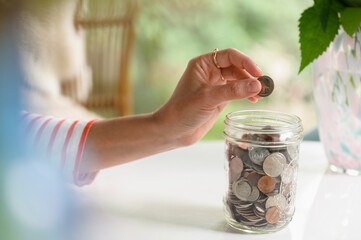 Putting a Coin in a Savings Jar