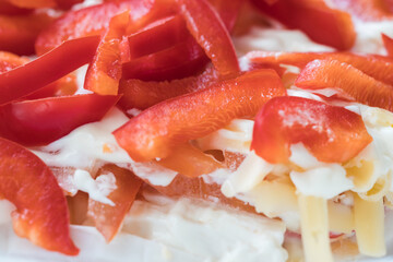 Red bell pepper salad. Pieces of sweet red pepper and cheese in mayonnaise, macro photography. Food backgrounds.