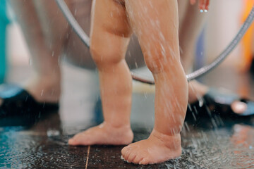 Mother helps little girl bath