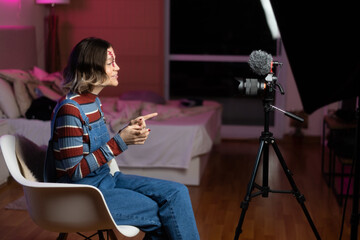 woman with a costume recording a halloween video at home