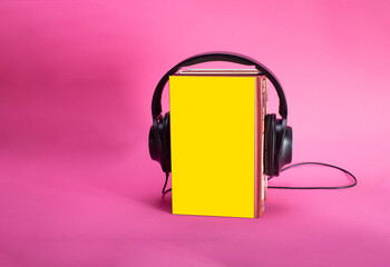 book and headphones. concept of audiobooks and education
